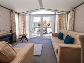 A living room with a sofa and table at Lodge - Plot 18 Near Sherburn