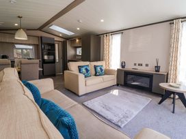 A living room with a sofa and rug at Lodge - Plot 18 Near Sherburn