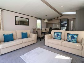 A living room with sofas and a dining area at Lodge - Plot 18 near Sherburn