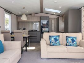 A living room with a dining area and kitchen in Lodge - Plot 18 Near Sherburn