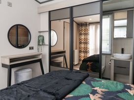 A bedroom with a bed and a desk at Lodge - Plot 18 Near Sherburn