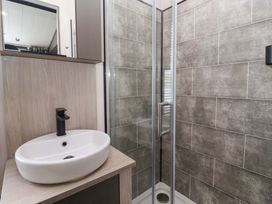A bathroom with a washbasin and shower at Lodge - Plot 18 Near Sherburn