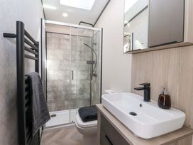 A bathroom with shower, toilet, sink, and towel rail at Lodge - Plot 18 Near Sherburn