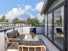 An outdoor terrace with a sofa and coffee table at Lodge - Plot 18 Near Sherburn