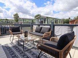An outdoor patio area with seating and a table at Lodge - Plot 18 Near Sherburn