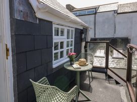 A balcony with a table and chairs at 15D Foss Street Dartmouth