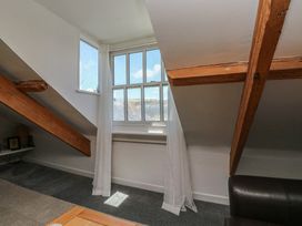 An attic space with windows and wooden beams at 15D Foss Street in Dartmouth