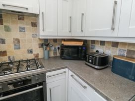 A kitchen with a gas stove, microwave, and toaster at 15D Foss Street, Dartmouth