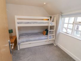 A bedroom with a bunk bed and a side table at 15D Foss Street in Dartmouth