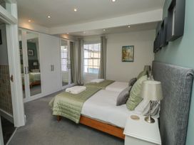 A bedroom with two beds and a wardrobe at 15D Foss Street in Dartmouth
