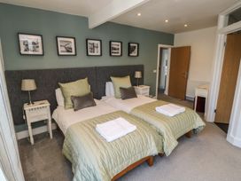 A bedroom with two beds and lamps at 15D Foss Street in Dartmouth