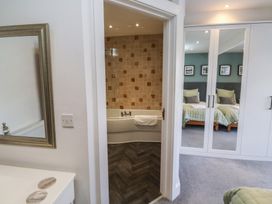 A bedroom with a bathtub visible in an adjacent bathroom at 15D Foss Street Dartmouth