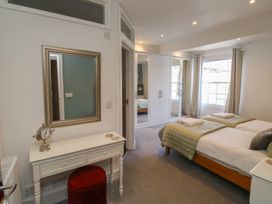 A bedroom with twin beds and a mirror at 15D Foss Street Dartmouth
