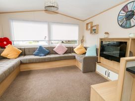 A living room with a sofa and television at Foxglove 4 in Ringwood