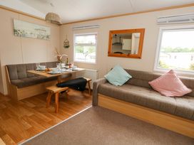 A living room with a dining table and seating at Foxglove 4 Ringwood
