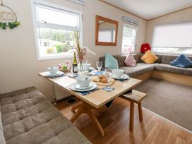 A dining area with a table set for meals at Foxglove 4 in Ringwood