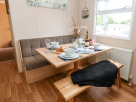 A dining room with a table set for meals at Foxglove 4 in Ringwood