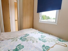 A bedroom with a bed and a window at Foxglove 4 Ringwood