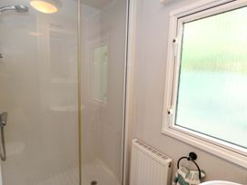 A bathroom with a shower and sink at Foxglove 4 in Ringwood