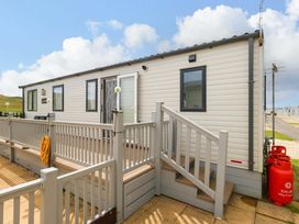 A caravan with a deck and steps at Caravan A7 in Bridport