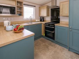 A kitchen with cabinets and countertop at Caravan A7 in Bridport