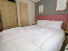 A bedroom with a bed and wardrobe at Caravan A7 in Bridport