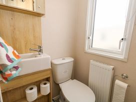 A bathroom with a toilet and sink at Caravan A7 in Bridport