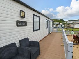 An outdoor area with seating and a nameplate at Caravan A7 in Bridport