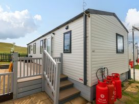 A caravan with steps and gas cylinders at Caravan A7 in Bridport
