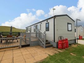 A caravan with steps and outdoor furniture at Caravan A7 in Bridport