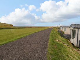 A path leading to mobile homes near the coast at Caravan A7 in Bridport
