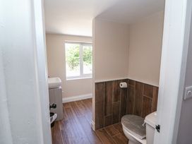 A bathroom with a toilet, sink, and window at Abinas in Kenmare