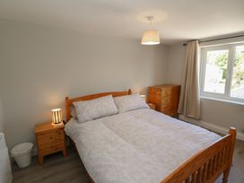 A bedroom with a bed and side tables at Abinas in Kenmare