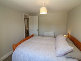 A bedroom with a bed and door at Abinas in Kenmare