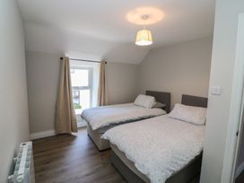 A bedroom with two beds and a window at Abinas in Kenmare