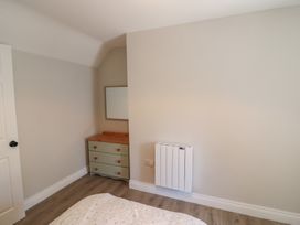 A bedroom with a dresser and mirror at Abinas in Kenmare