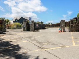 An entrance with a parking sign and gates at Abinas in Kenmare