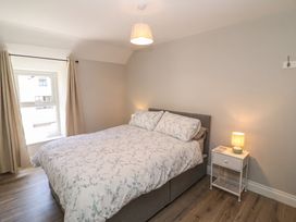 A bedroom with a bed and nightstand at Abinas Kenmare