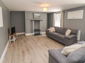 A living room with a television and a sofa at Abina's Kenmare, County Kerry