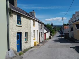 A street view with stone houses and a church steeple at Abina's, Kenmare, County Kerry
