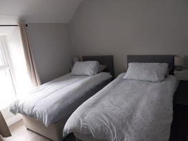 A bedroom with two single beds and bedside tables at Abina's, Kenmare, County Kerry