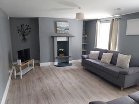 A living room with a television and fireplace at Abina's in Kenmare, County Kerry