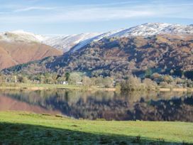 A lake surrounded by mountains and trees at Flat 4 Grasmere Lodge Ambleside