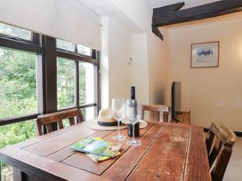 A dining room with a table and chairs at Flat 4 Grasmere Lodge in Ambleside