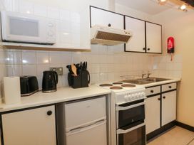 A kitchen with stove and sink at Flat 4 Grasmere Lodge in Ambleside