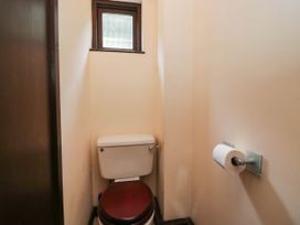 A bathroom with a toilet and window at Flat 4 Grasmere Lodge in Ambleside