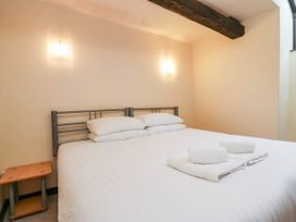 A bedroom with a bed and towels on top at Dunmail Raise, Grasmere Lodge Grasmere