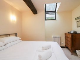 A bedroom with a bed and a dresser at Dunmail Raise, Grasmere Lodge, Grasmere