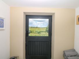 A door and window with a view of fields at Reddaway Byre Okehampton