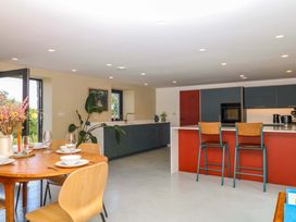 A kitchen with table and chairs at Reddaway Byre in Okehampton